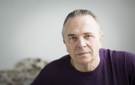 Image of conductor Sir Mark Elder, wearing a purple jumper